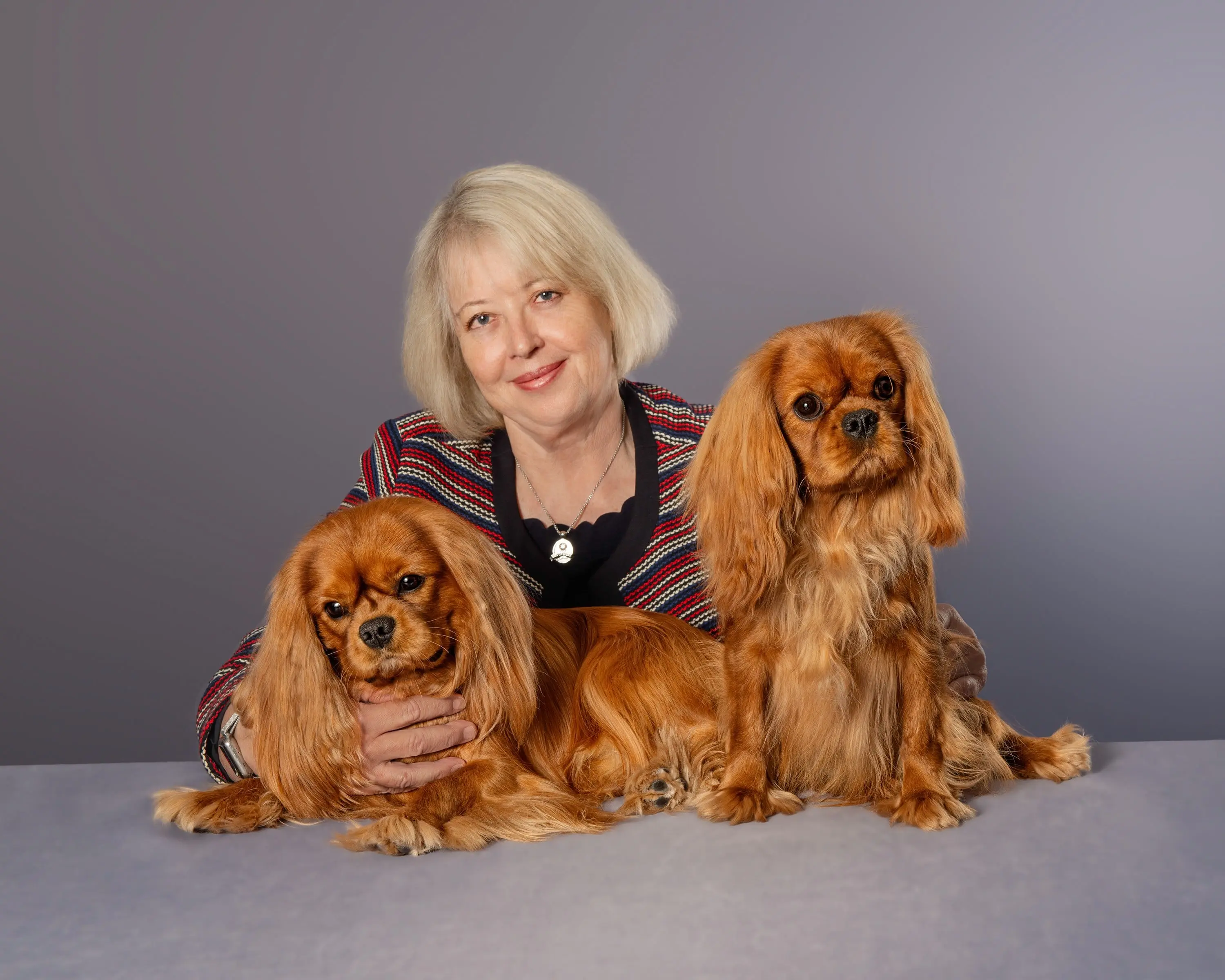 Dorothy Swanson with two ruby Cavaliers