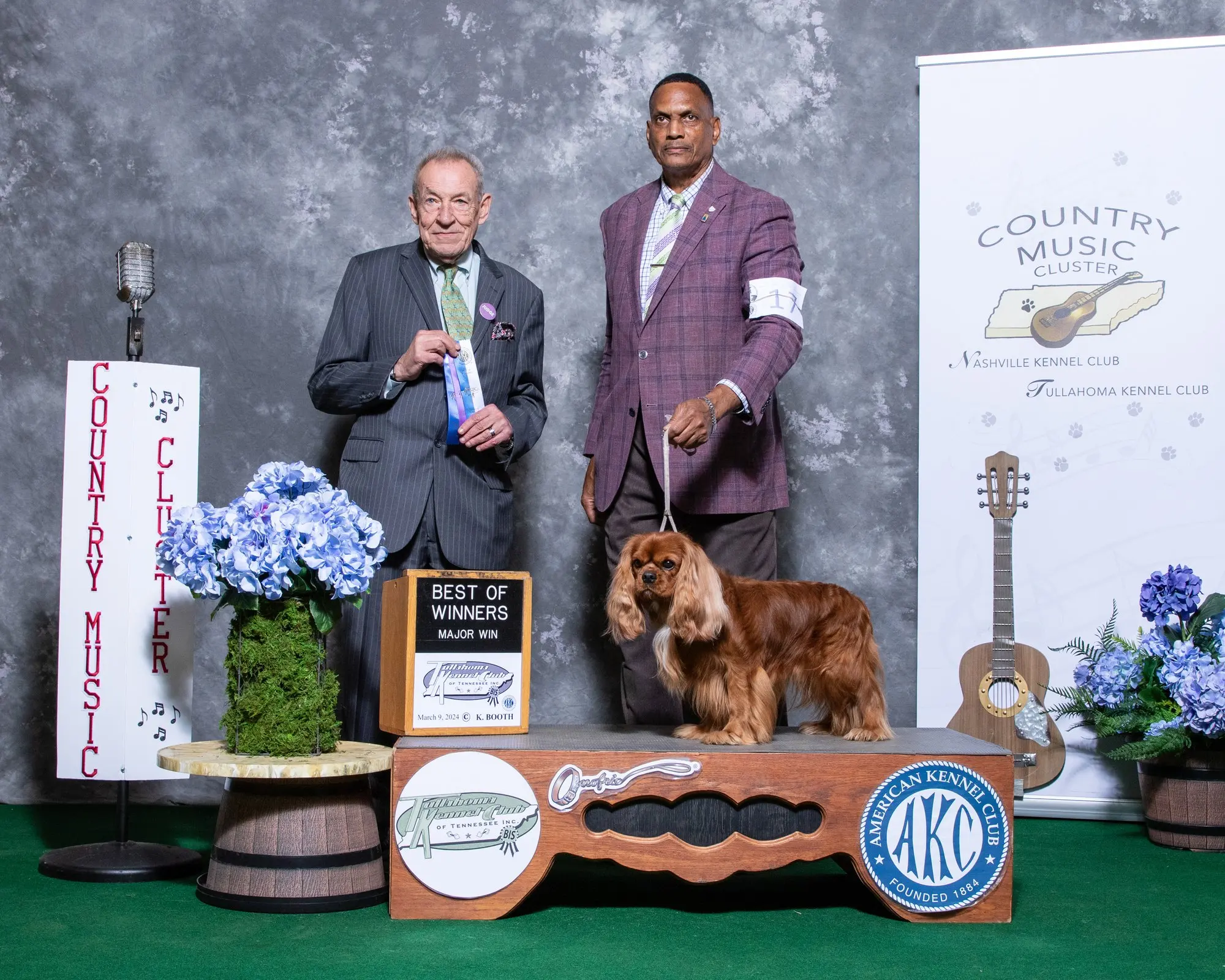 Graham on the podium with a Best of Winners Major Win sign at the Country Music Cluster